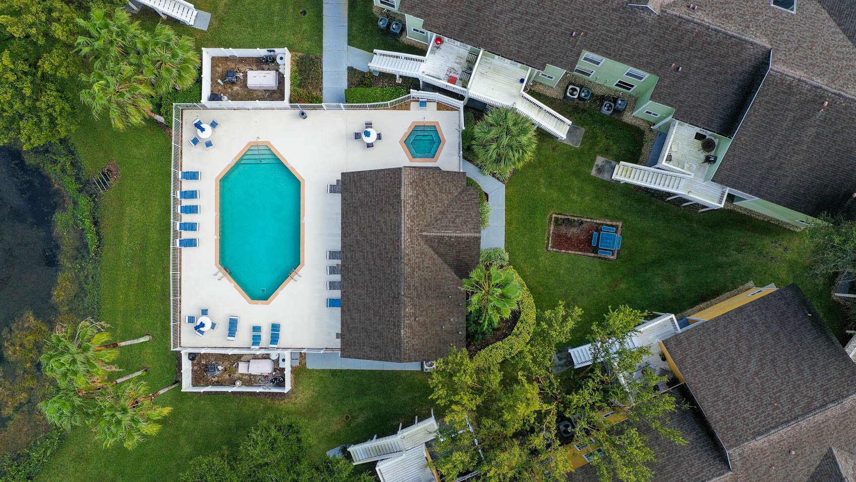 drone shot of pool with clubhouse